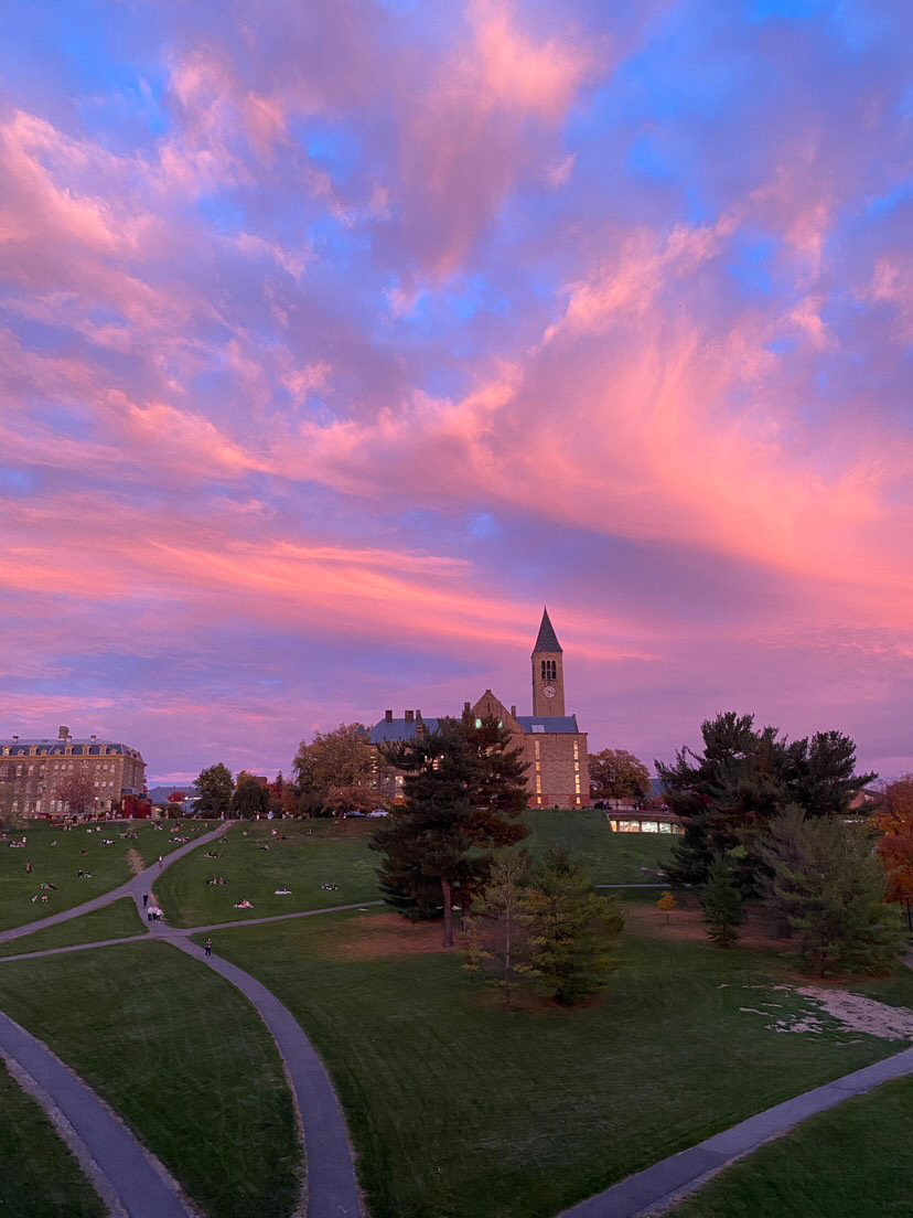 A swirling pink sunset over Libe Slope and McGraw Tower at Cornell University.