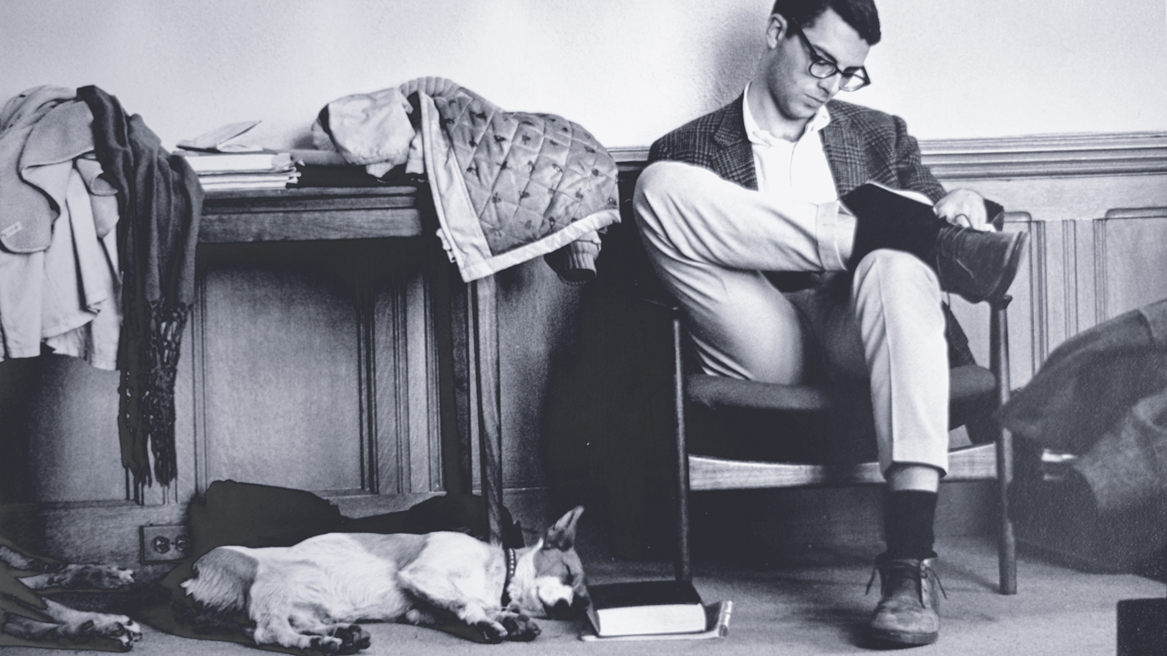 Dogs sleeping as a student studies, a typical sight on campus in the 1950s