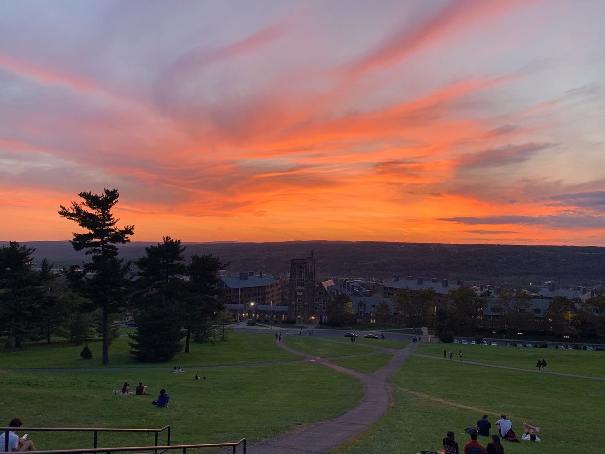A light orange and gray sunset over Libe Slope at Cornell University.