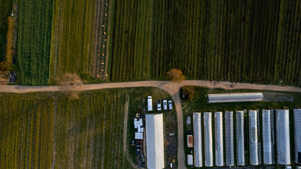 An overhead view of farm buildings and fields.
