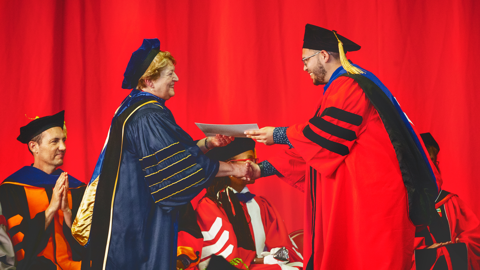 Kathryn Boor ’80, dean of the Graduate School and vice provost for graduate education, congratulates a successful Ph.D. candidate