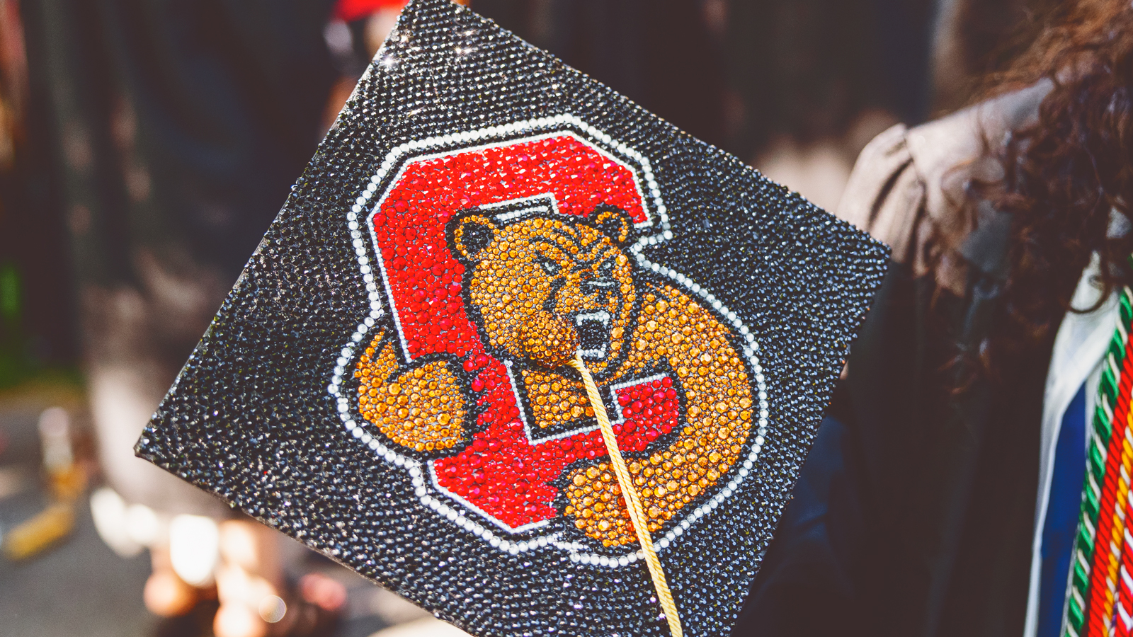 detail of a blinged-out mortarboard at Commencement 2023