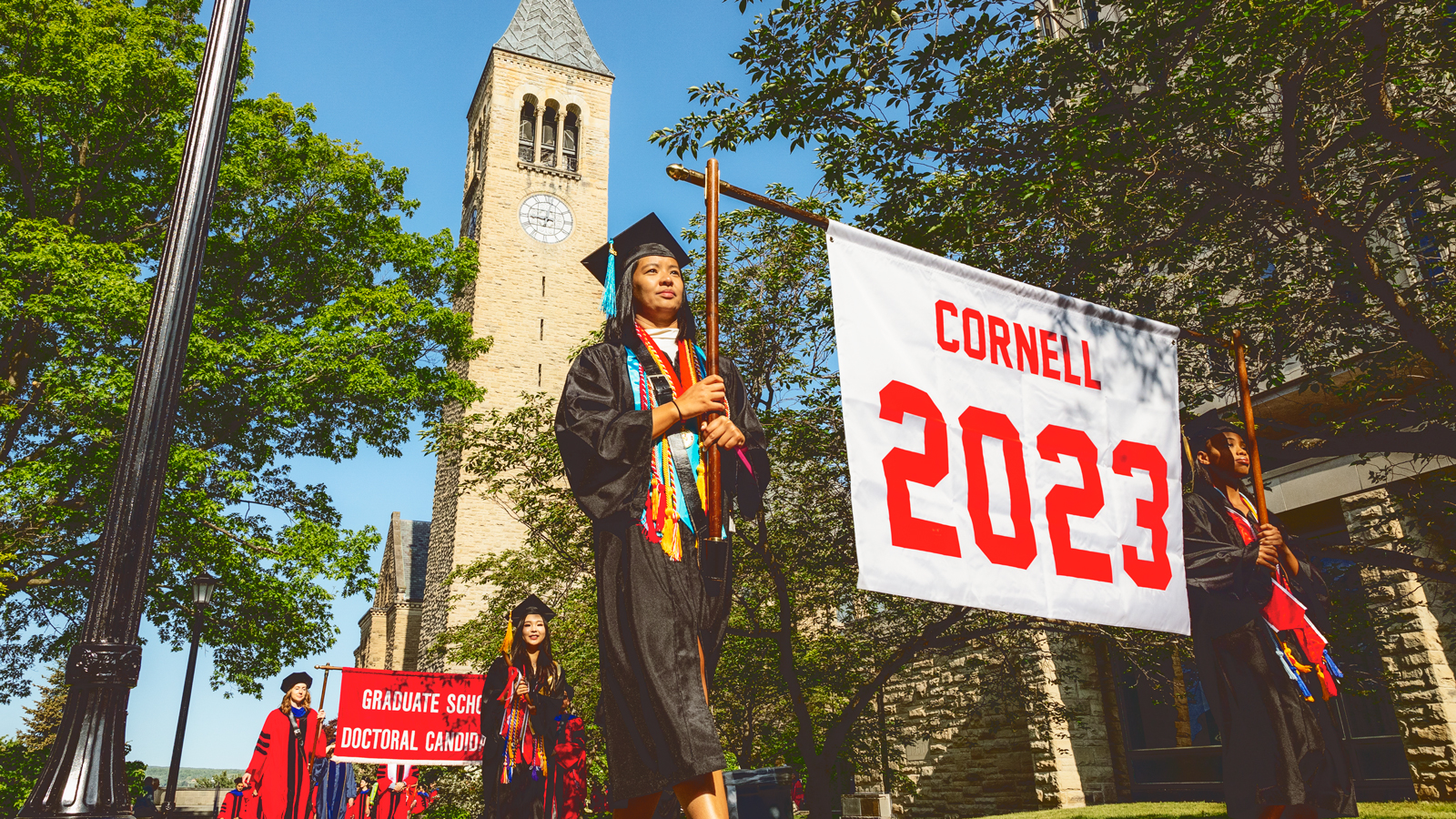 The front of the academic procession passes McGraw Tower during Commencement 2023
