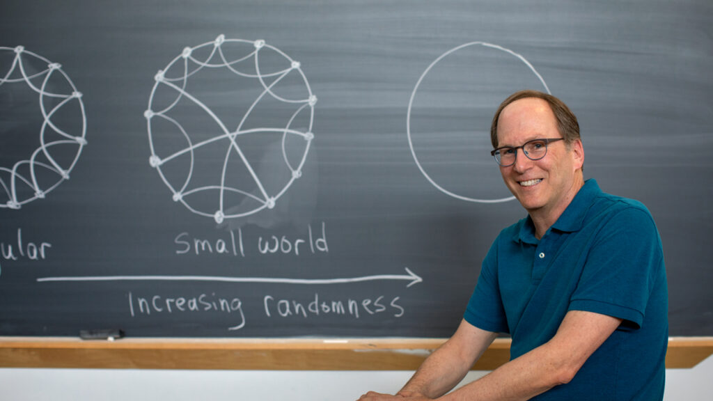 Prof Steve Strogatz in front of a chalkboard