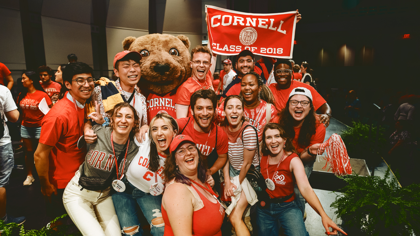 Cornellians and Touchdown the Bear celebrate at Cornelliana in Bailey Hall during Reunion 2023