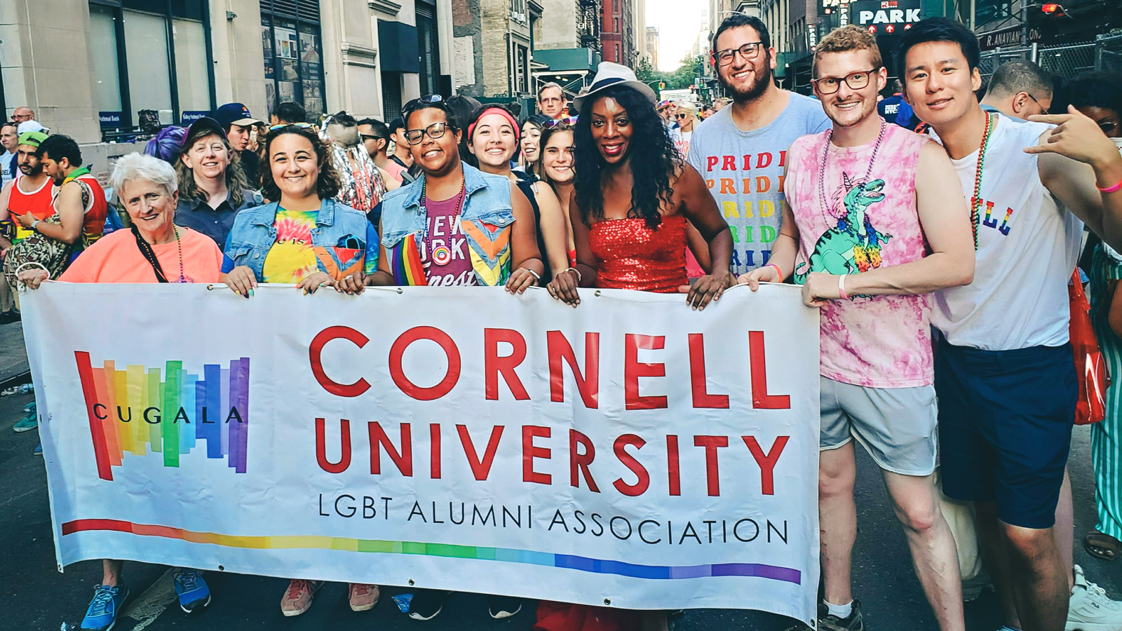 Cornell Pride members with a banner at a parade