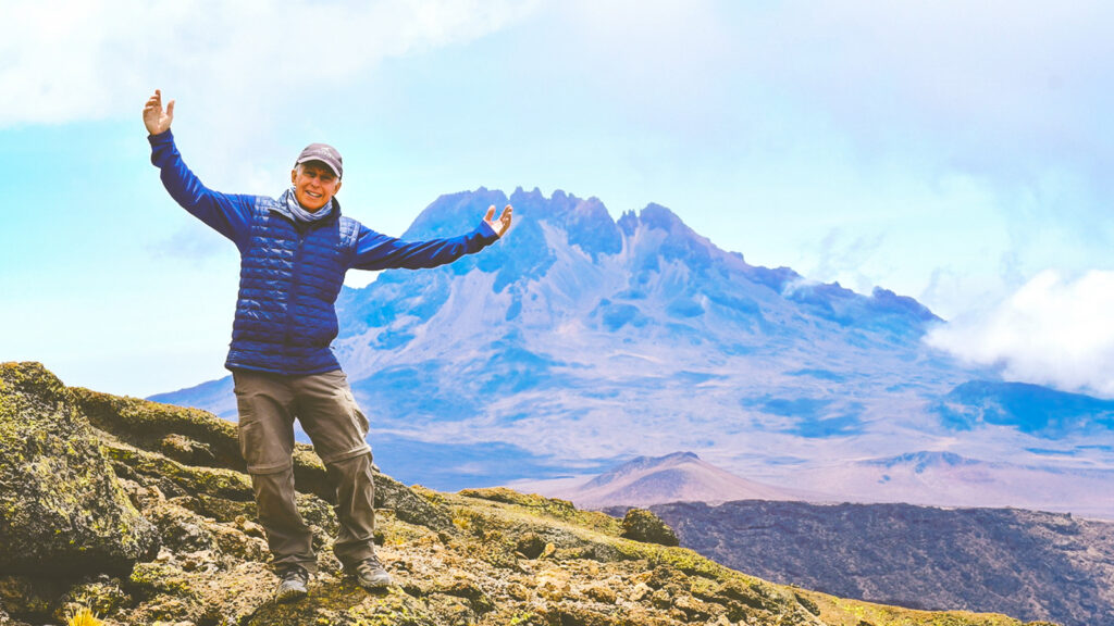 A man at the summit of Mount Kilimanjaro