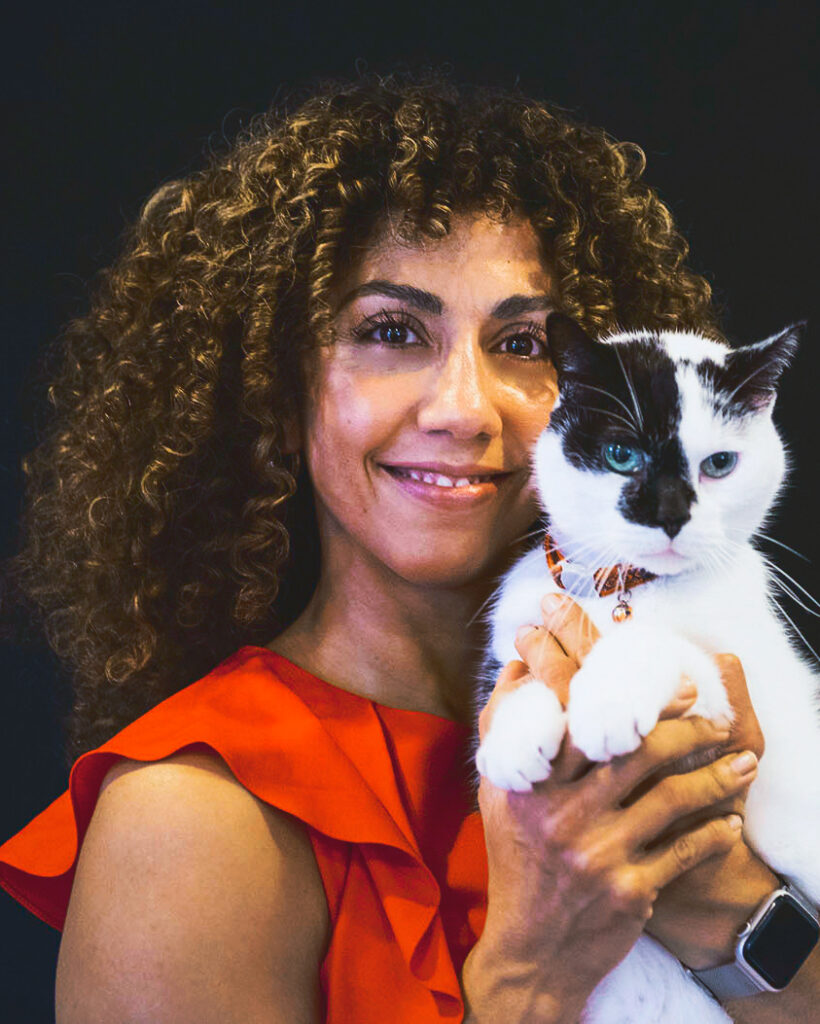 Dr. Michelle Moyal with a black and white cat