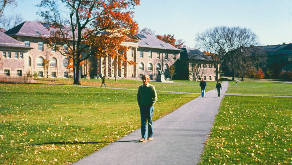 A person walking through a college campus