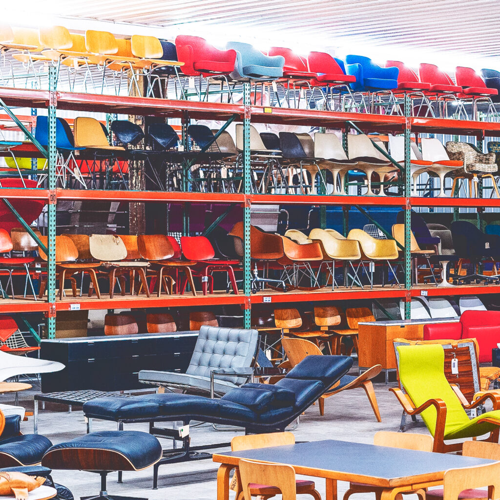 A furniture showroom with various chairs on display in an array of colors