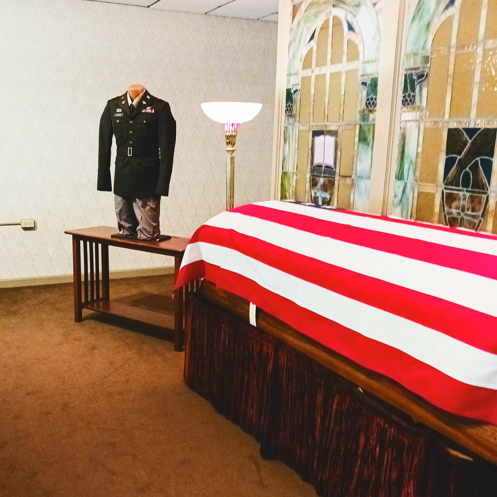 A military funeral with a casket covered by an American flag