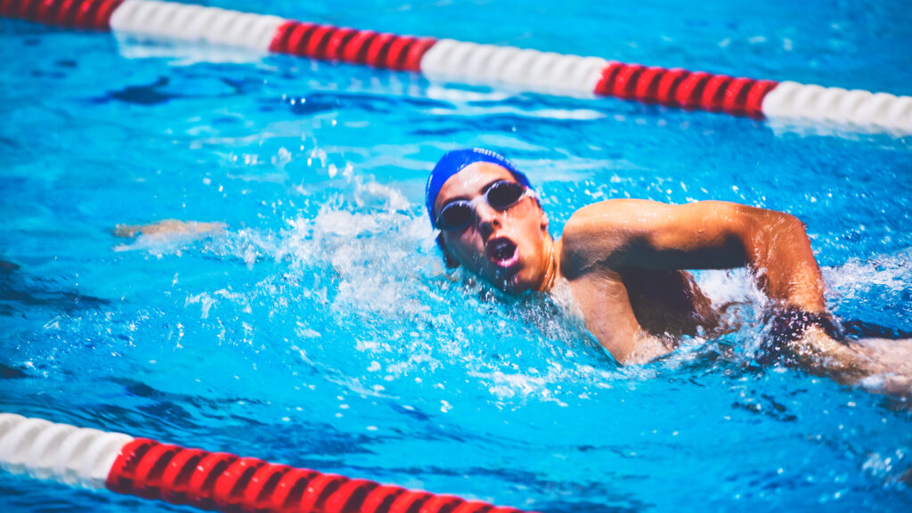 A close up of a student swimming.