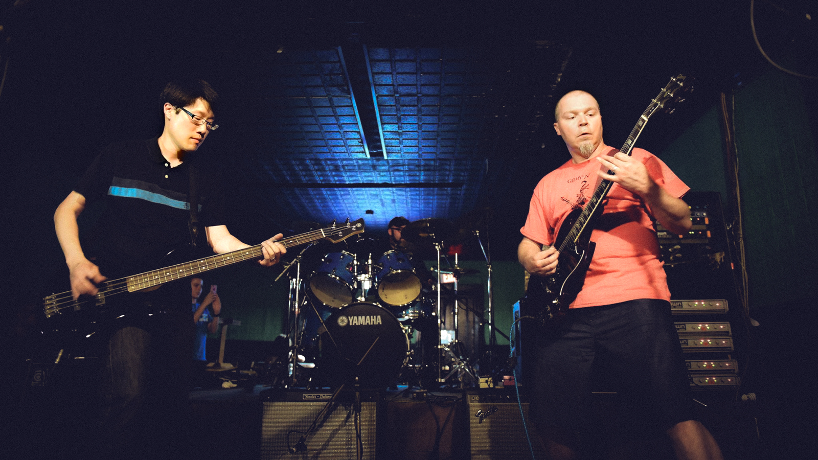 Two men performing in a punk rock group.