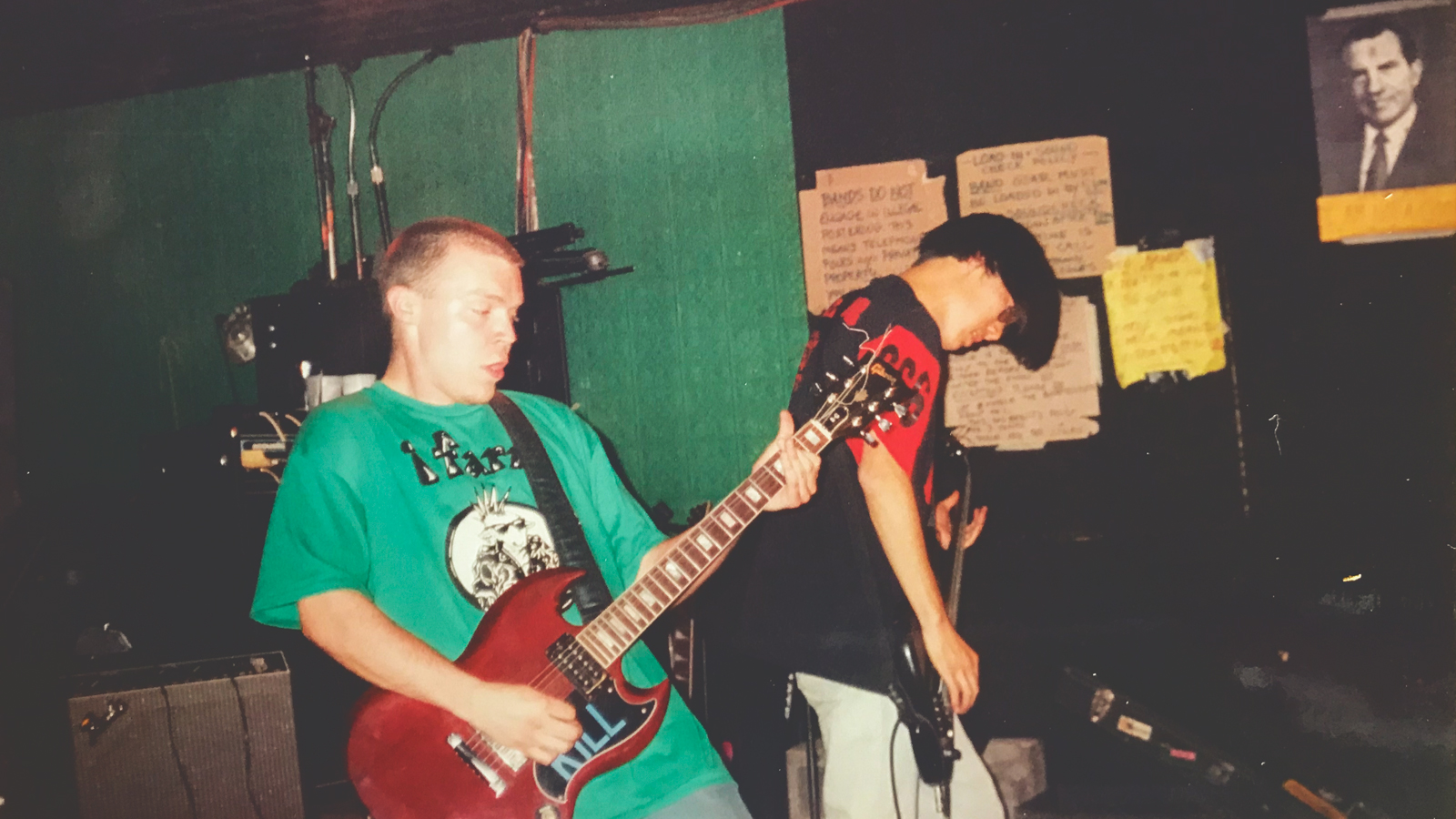 Two young men performing in a punk rock group.