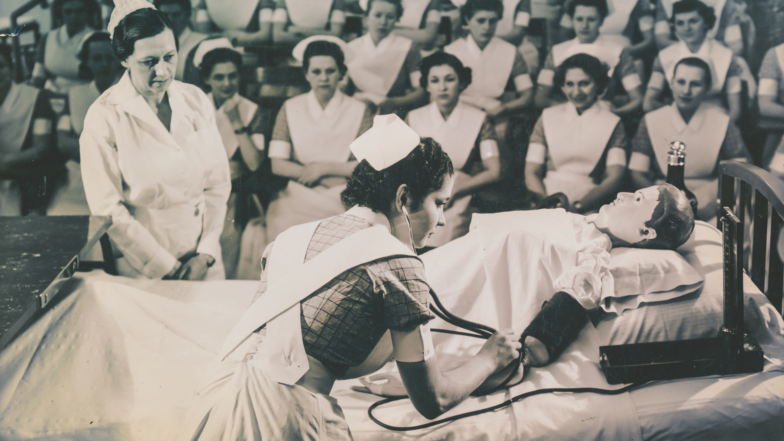 Practicing blood-pressure measurement in a nursing arts class, ca. 1930s