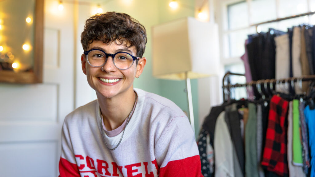 Alex Nik Pasqualini, co-founder of the Life Transitions Closet and Ph.D. candidate in music, poses for a portrait at the Life Transitions Closet in the LGBT Resource Center on Wednesday, September 28, 2023. (Ryan Young / Cornell University)