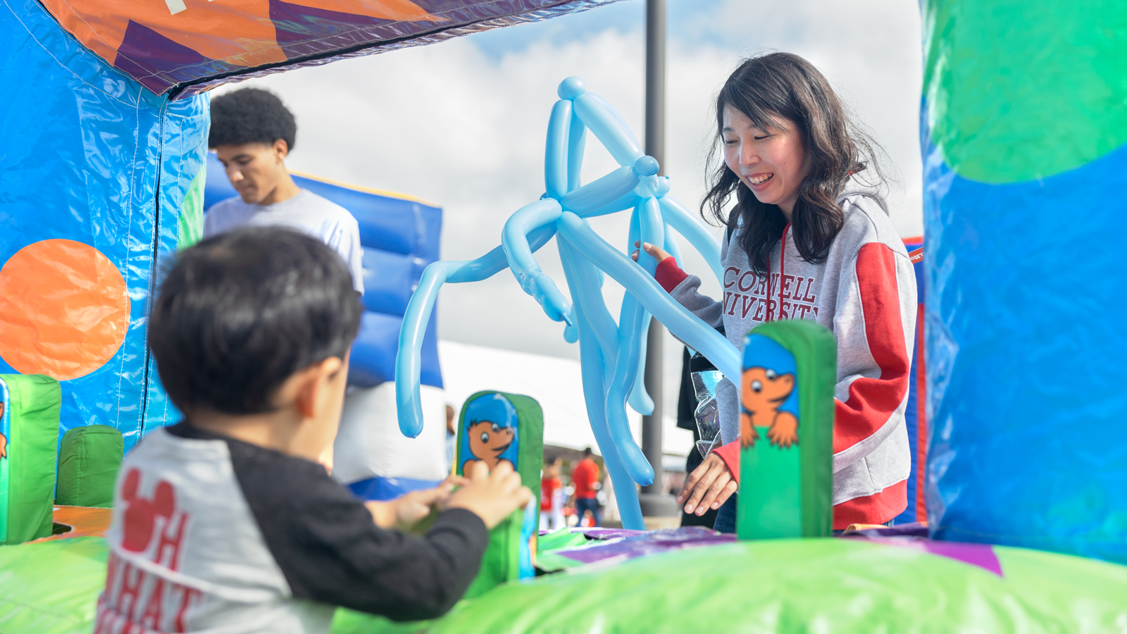 Balloon animals and activities for kids at the Fan Festival during Homecoming