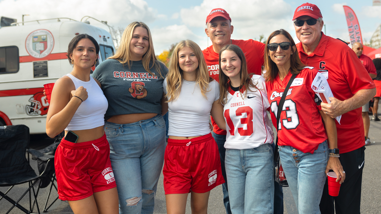 A family poses for a portrait at the Fan Festival outside Schoellkopf Stadium