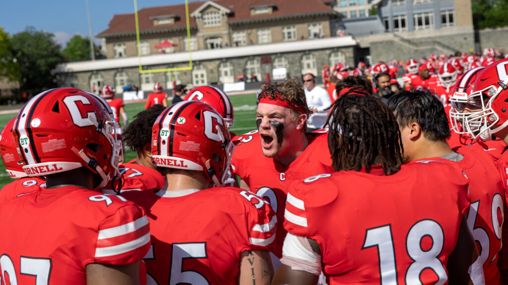 Members of the Big Red football team get amped up before the Homecoming game at Schoellkopf Field