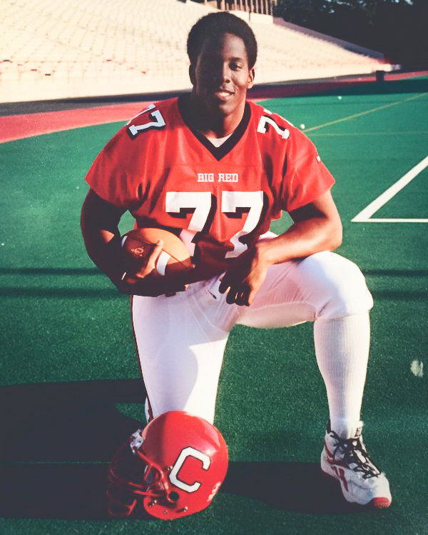 Kevin Boothe kneeling on the field in his Cornell football uniform as a student
