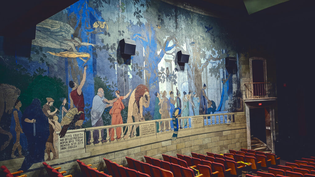 Colorful murals on the walls of a 100-year-old movie theater
