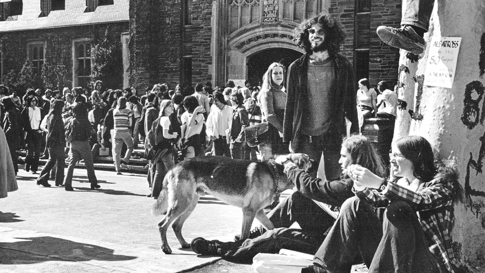 students—and at least one dog—hang out in front of Willard Straight Hall in the late ’60s/early ’70s