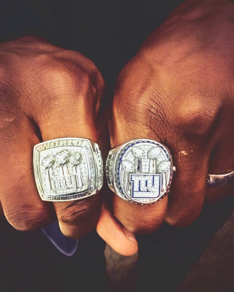 Kevin Boothe's hands displaying his two Super Bowl championship rings