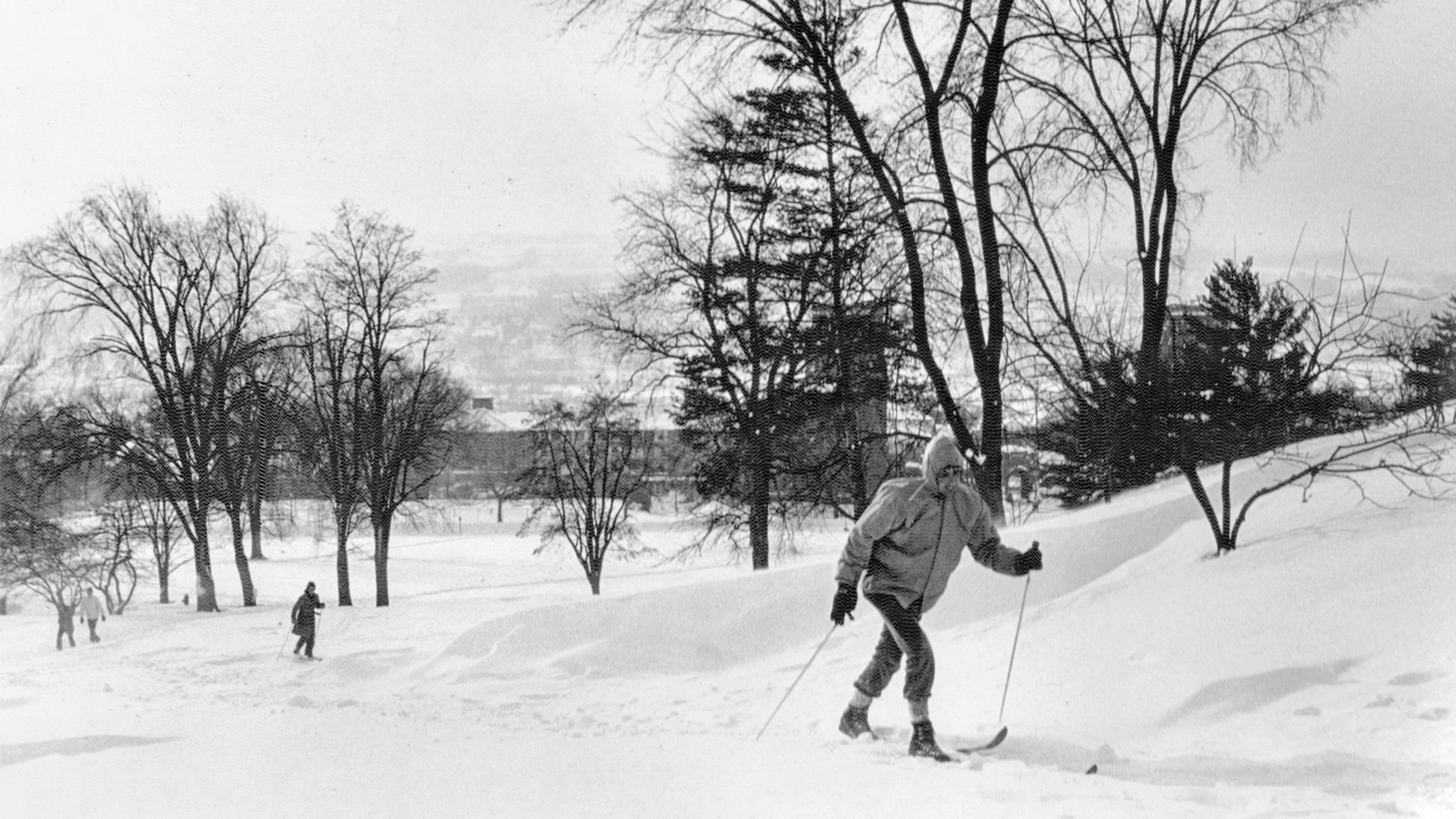 Students cross-country ski up Libe Slope in winter