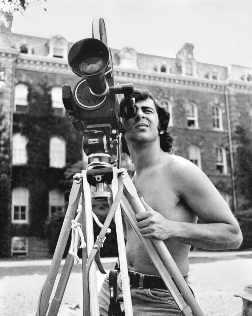 a student films with a movie camera on the Arts Quad