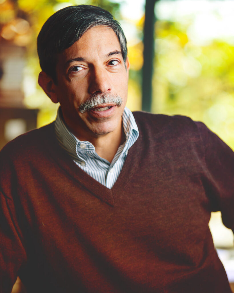 A portrait of Fred B. Schneider from Cornell University wearing a brown sweater and blue collared shirt underneath.