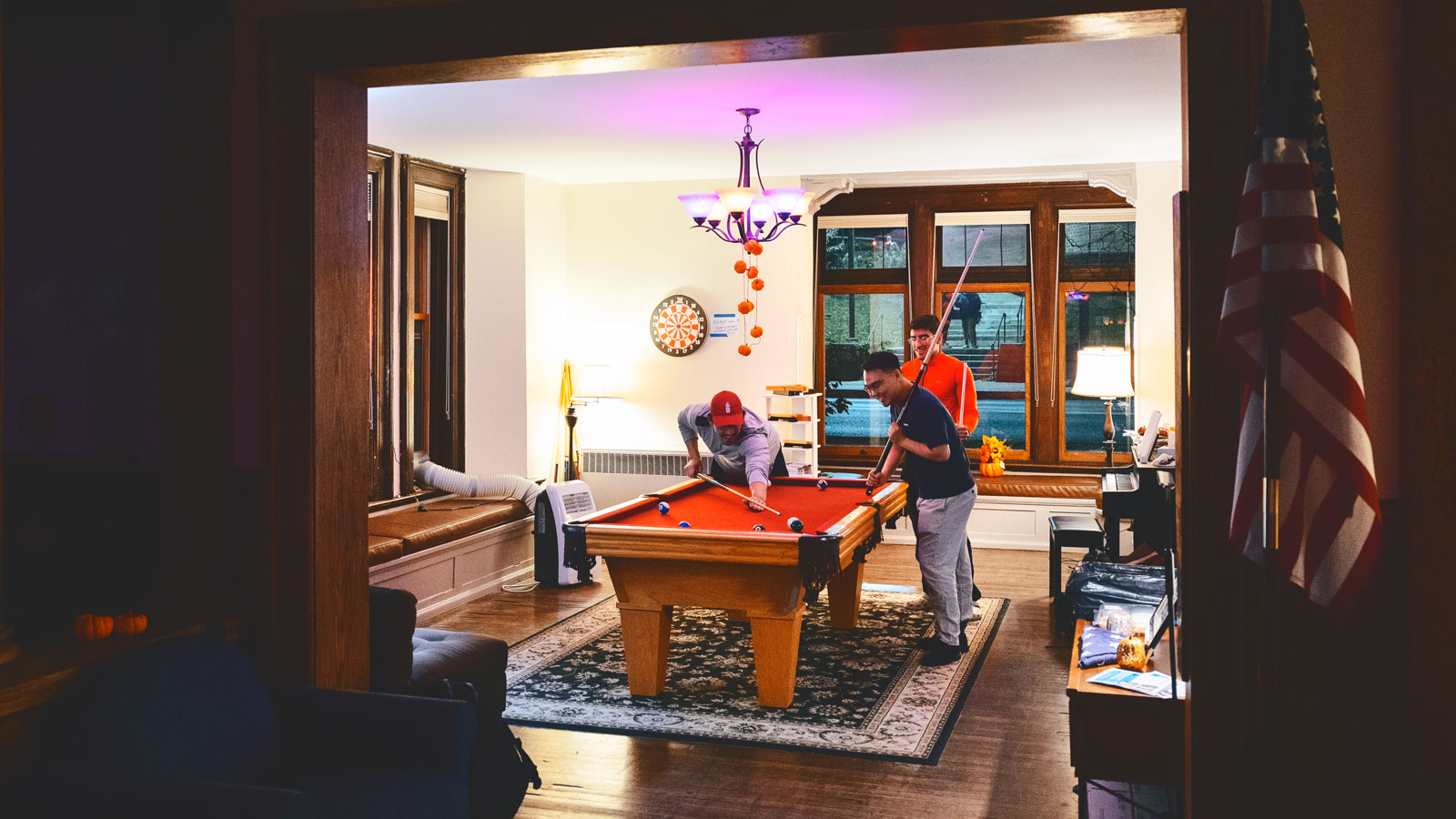 Students play pool at the Veterans House just off West Campus