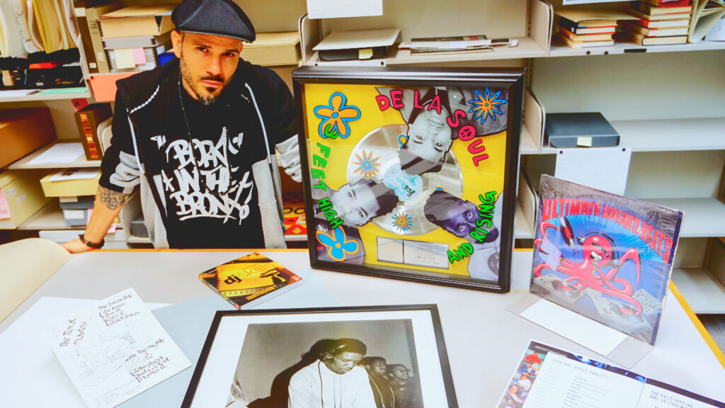 Ben Ortiz, collections specialist of the Cornell Hip Hop Collection, holds a platinum record by De La Soul that is among the artifacts on display at the rotunda of Cornell University Library’s Division of Rare and Manuscript Collections