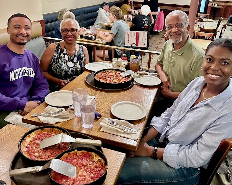 Melanie Stewart, Evan Reynolds, Rodney Reynolds, and Rodney's wife Donna at a table in a pizza restaurant