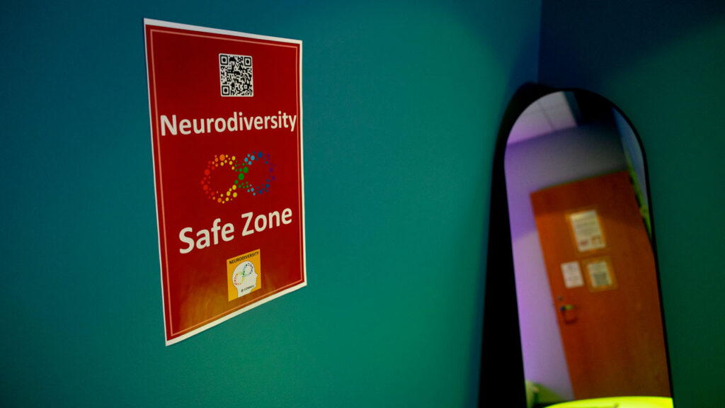 A sign on a wall saying Neurodiversity Safe Zone