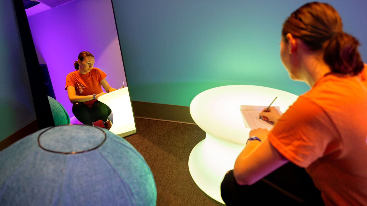 Doctoral student Becca McCabe, MS ’23, signs in to the Sensory Room.