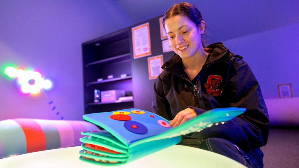 Alesandréa Rodriguez ’27, an animal science major in CALS, peruses a sensory book provided by The Sensory Room