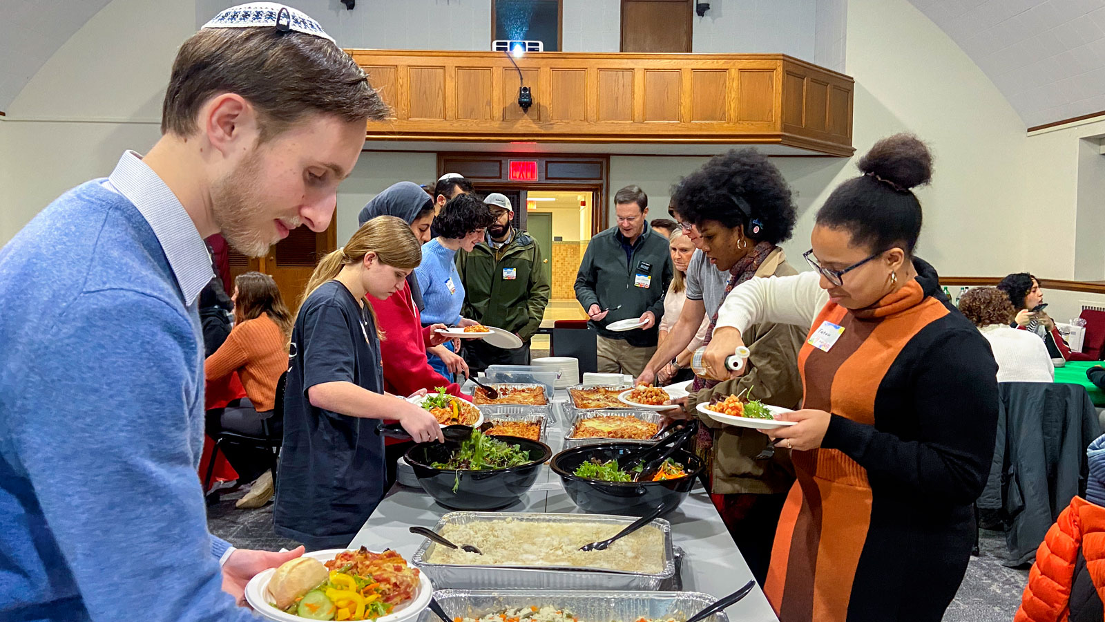 Students at a buffet during an interfaith dinner in Anabel Taylor Hall