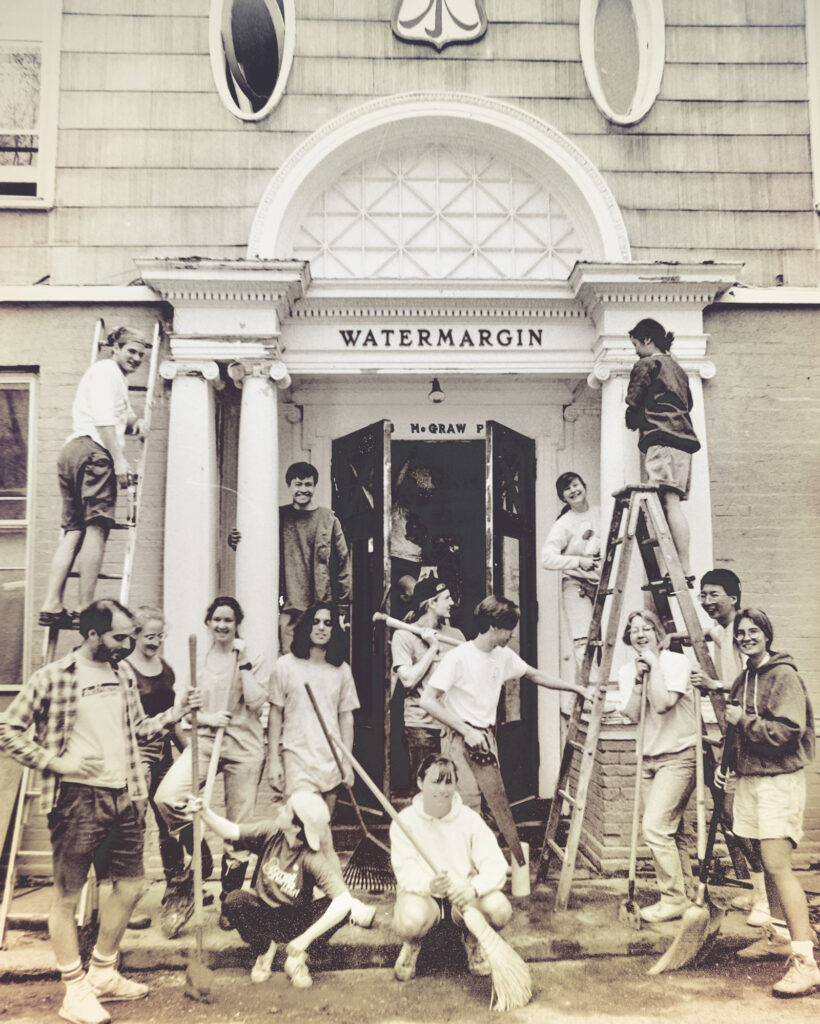 Watermargin members recreate the original house-prepping photo in 1992