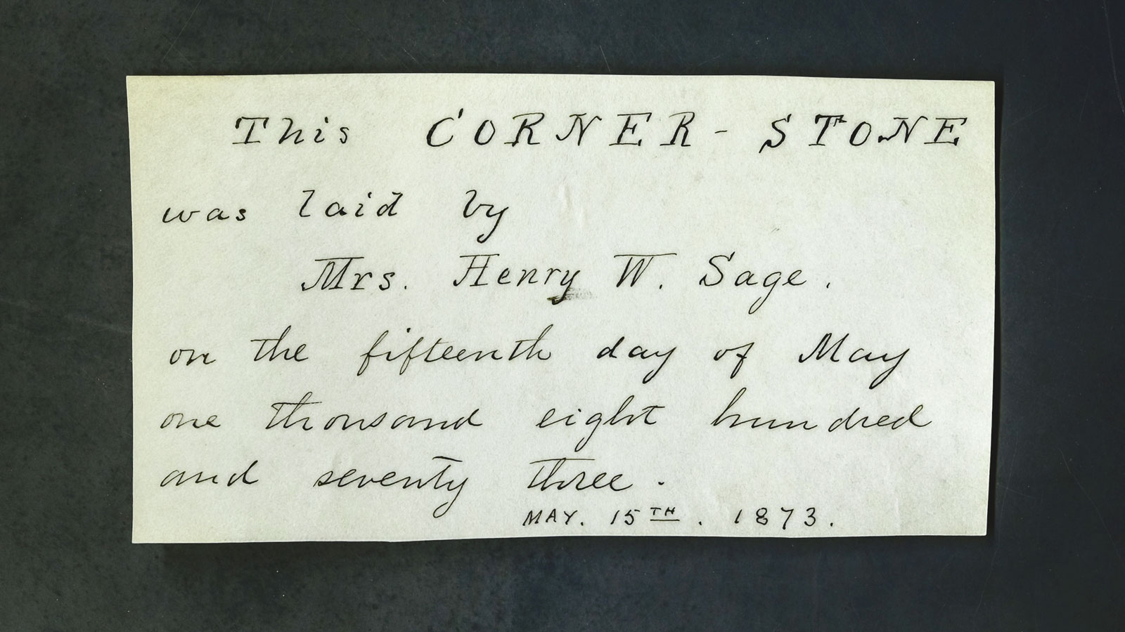 A small, handwritten card is among the Sage Hall cornerstone box’s contents