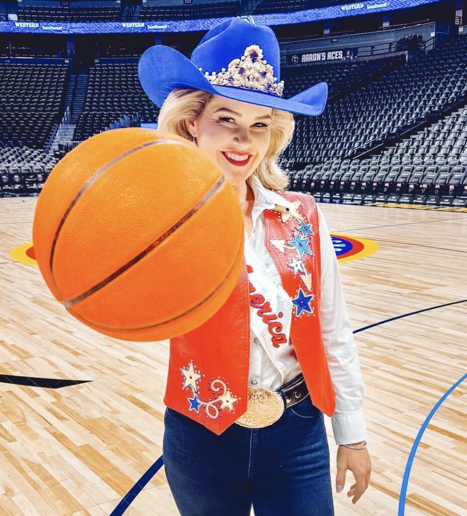 Emma Cameron holding a basketball at a Denver Nuggets game