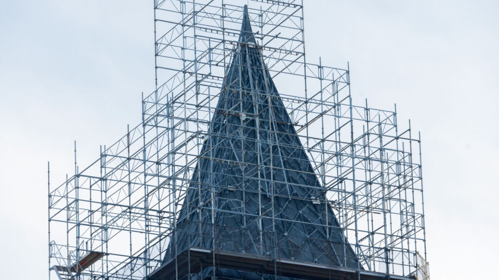 A close up of the roof of McGraw Tower surrounded by scaffolding