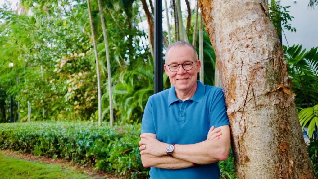 John Toohey-Morales relaxes in a Miami park near his home
