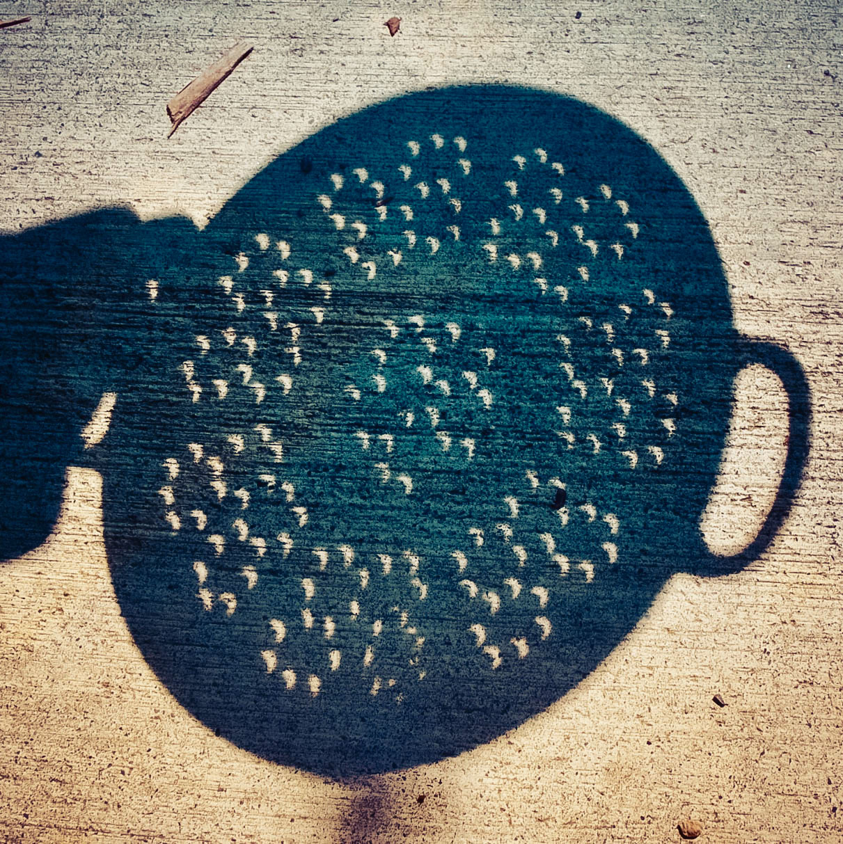 The view of an eclipse through the shadow of a colander