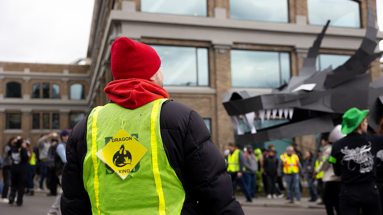 Dragon crew member in reflective vest and caution sign at Dragon Day 2024