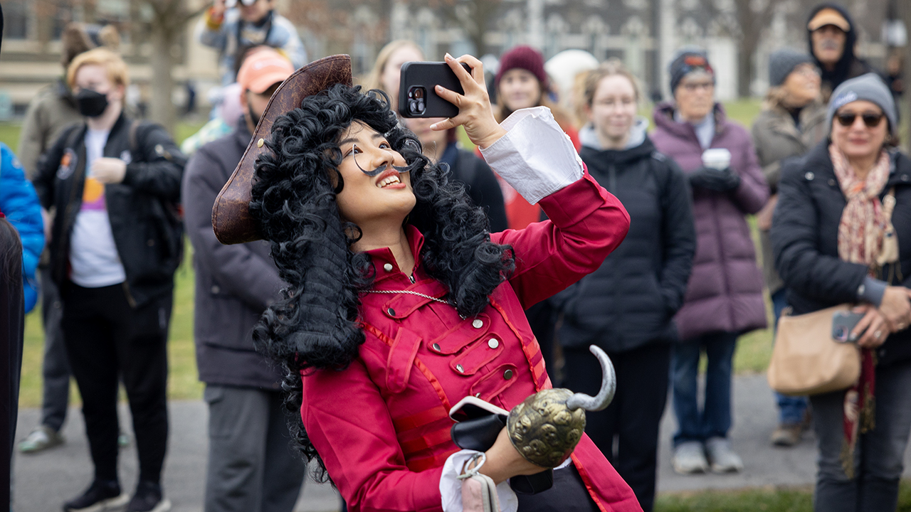 Parade-goer dressed as a pirate takes a selfie at Dragon Day 2024