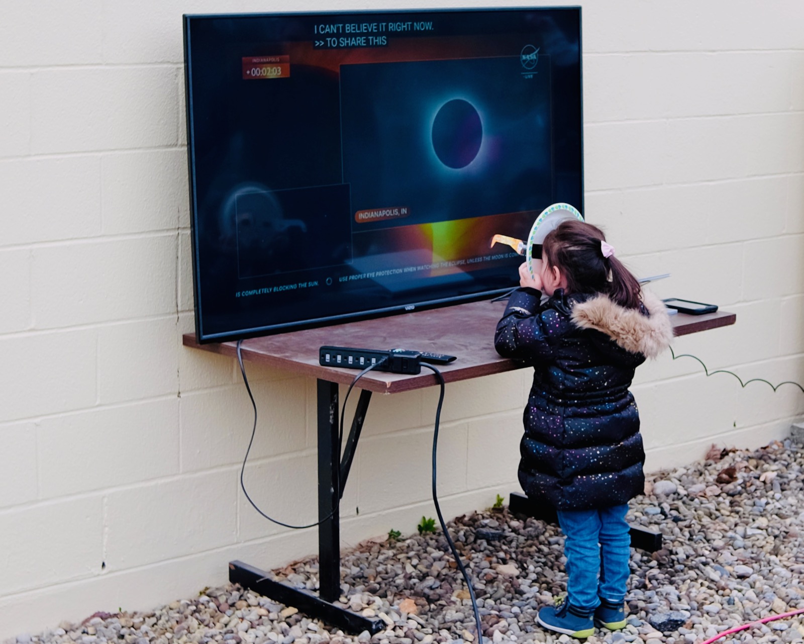 A very young eclipse fan watches a streaming view on the Geneva campus