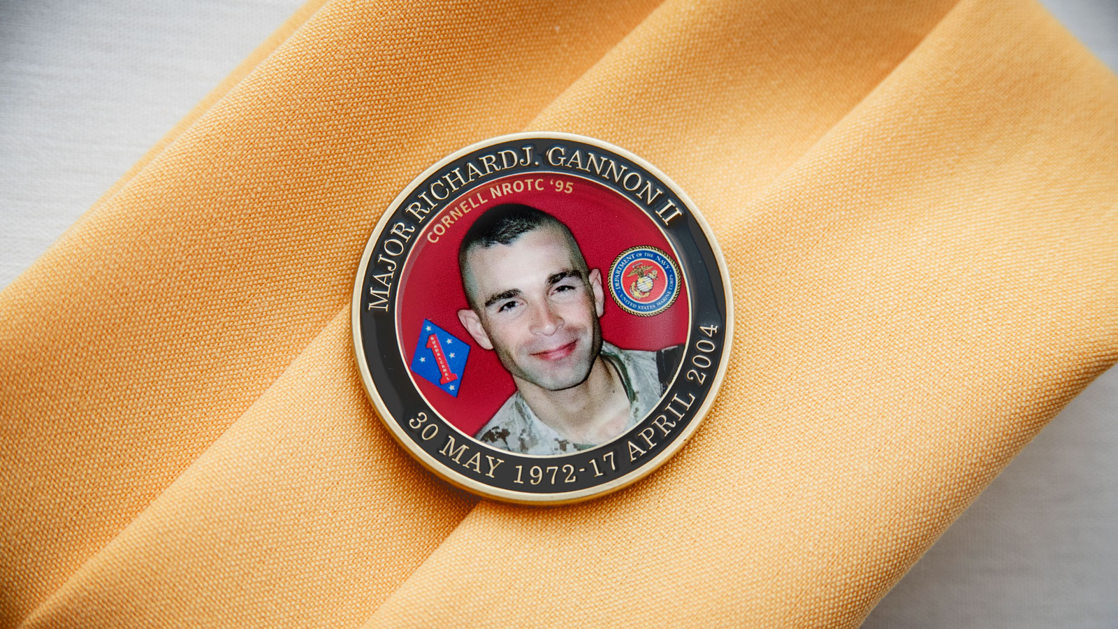 A memorial coin with a photo of Rick Gannon