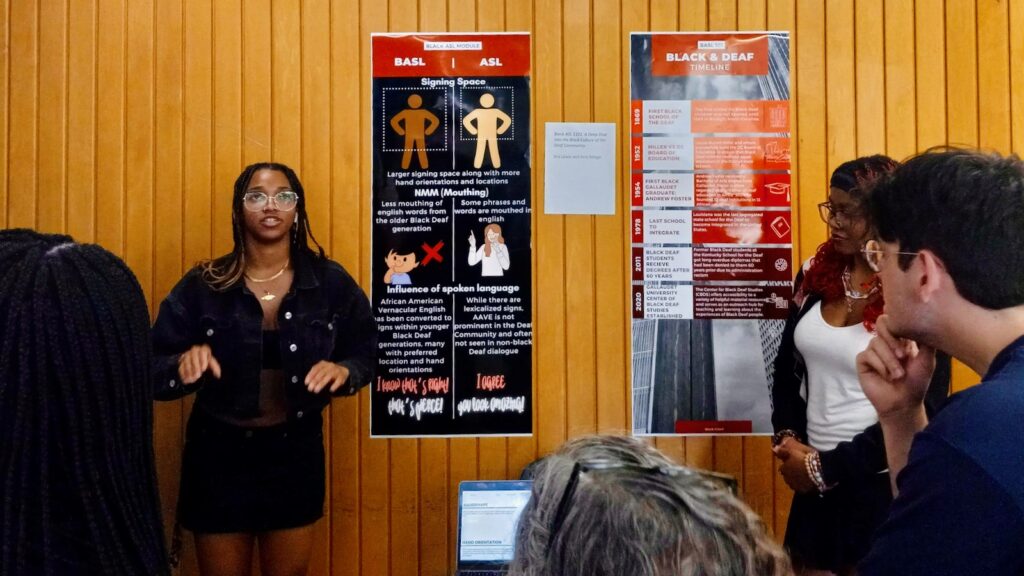 A student presents research findings at the ASL Symposium held May 1 in Morrill Hall