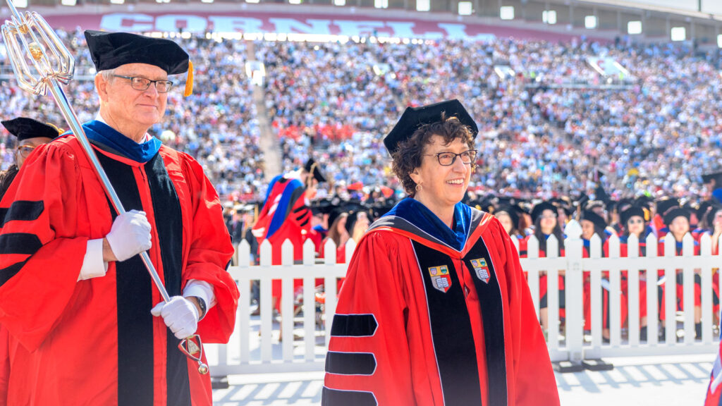 Professor Emeritus and mace bearer David Lee and President Martha Pollack during the academic procession at Schoellkopf Field, Commencement 2024