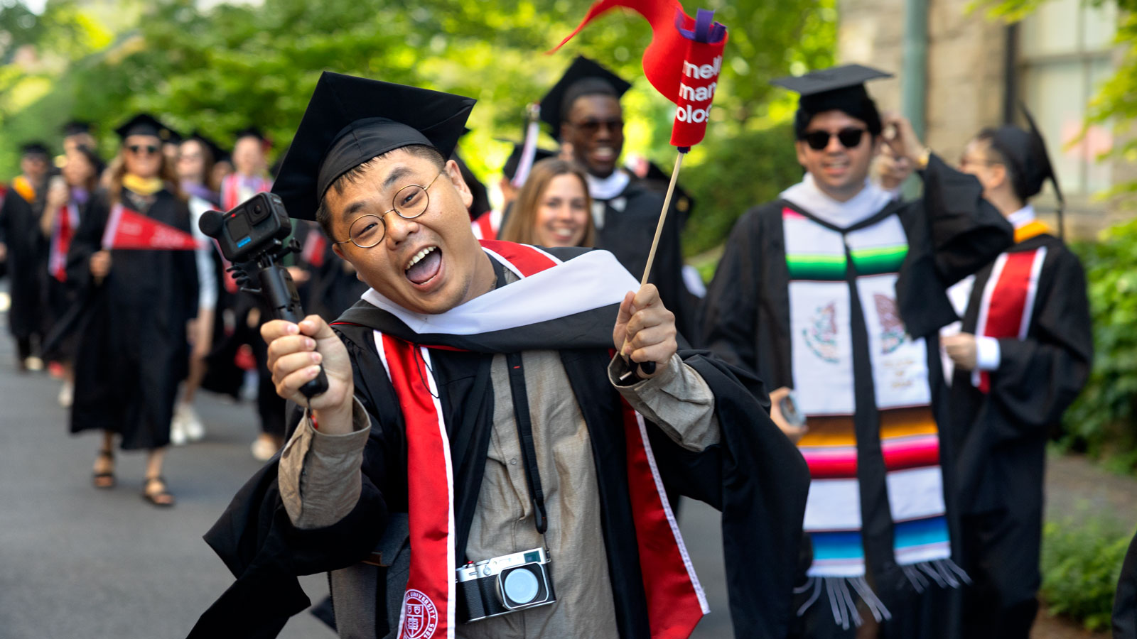 A graduate celebrates during the academic procession as part of Commencement 2024 events